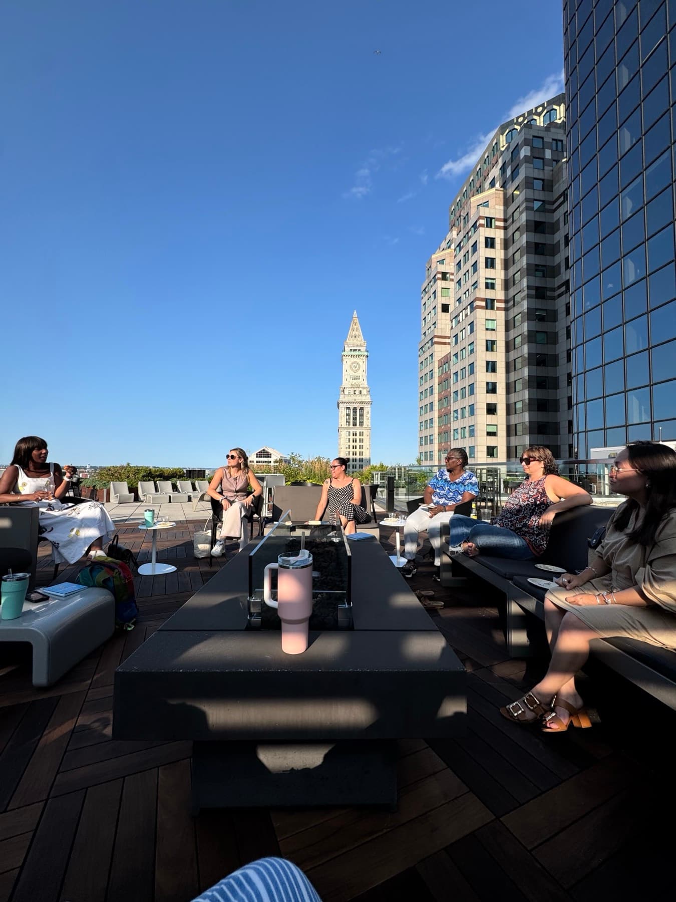 Tenants gathered at a rooftop event with the city skyline behind them