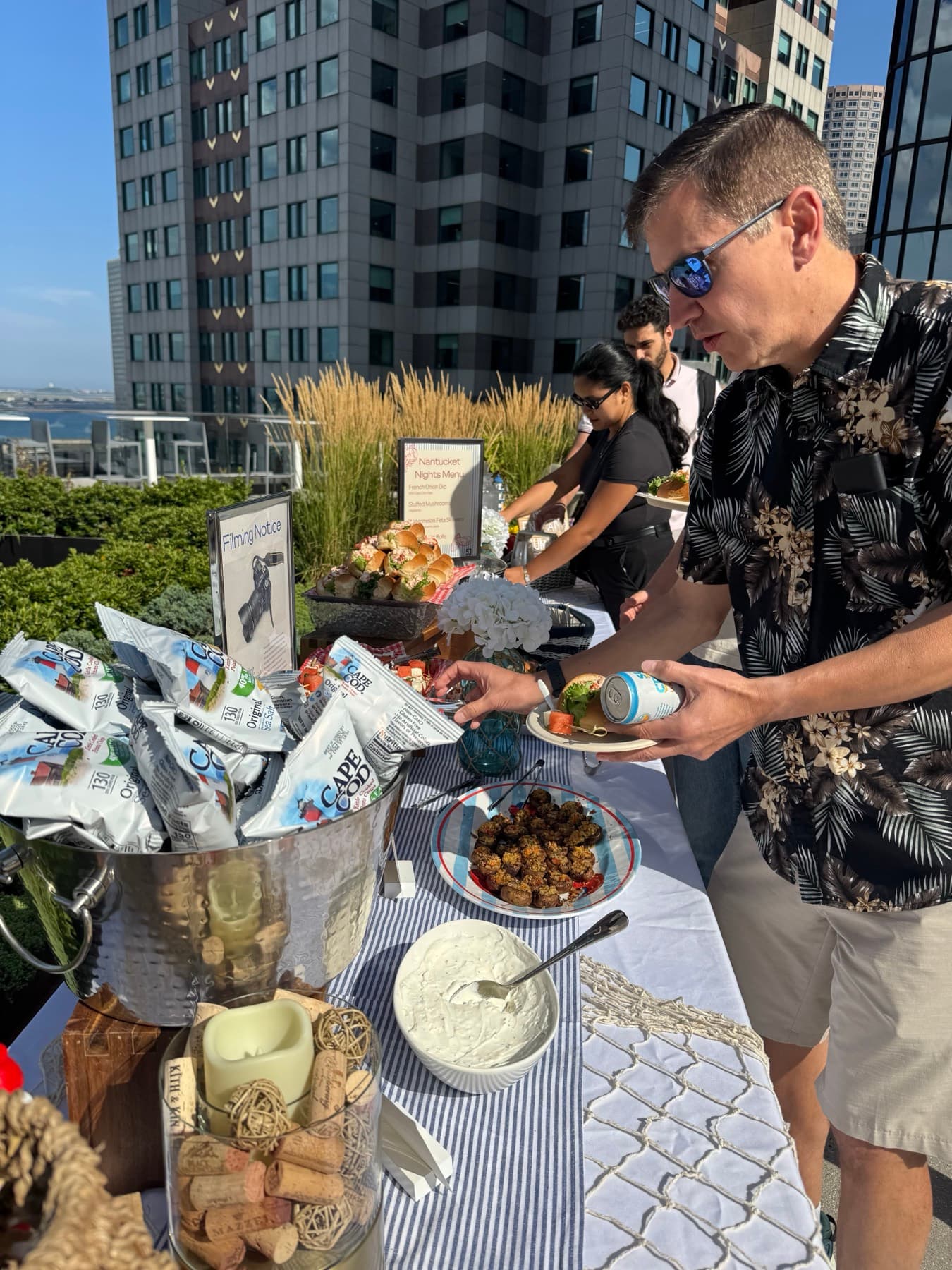 Tenants enjoying food and drinks at a rooftop social